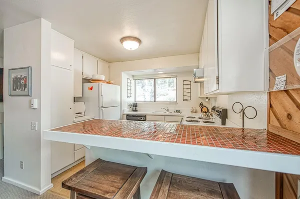 a kitchen with sink cabinets and outdoor space
