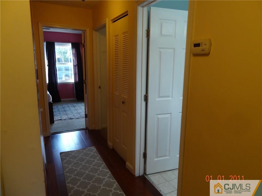1019 Edpas Road, Unit 1019 New Brunswick, NJ 08901 - Photo 13 of 18 a view of a hallway with wooden floor and a bathroom