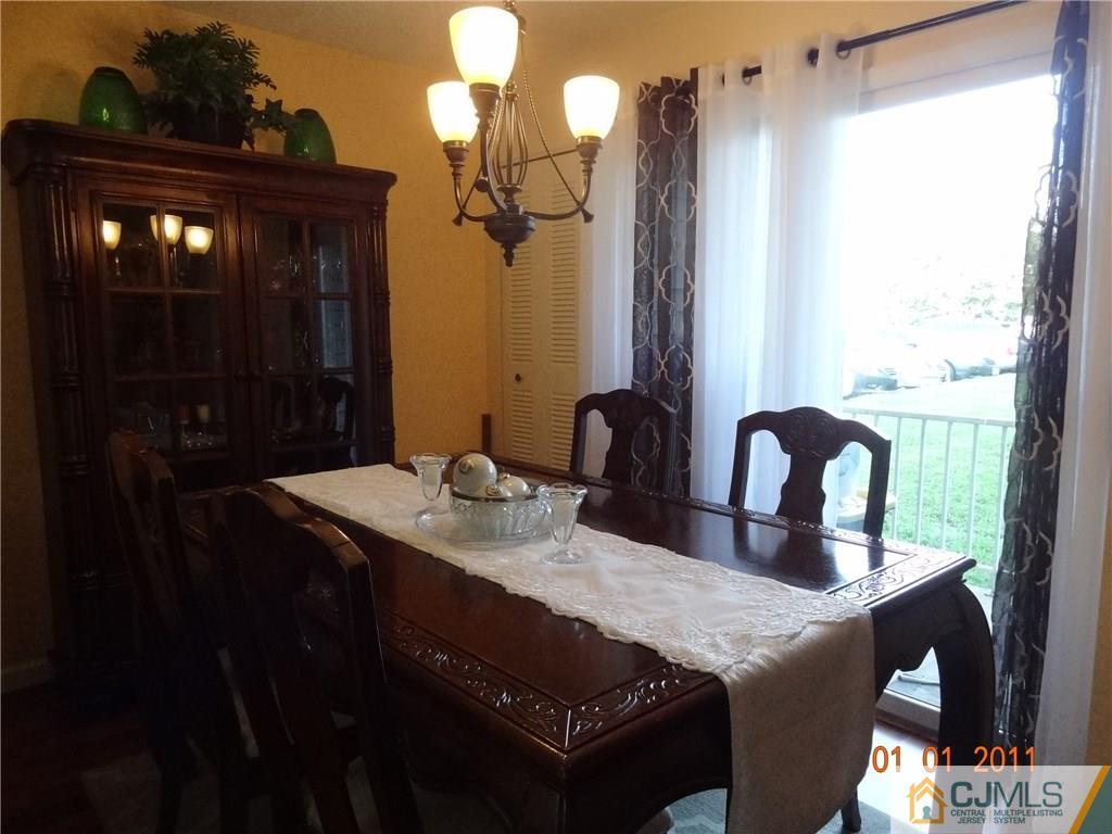1019 Edpas Road, Unit 1019 New Brunswick, NJ 08901 - Photo 6 of 18 a view of a dining room with furniture and chandelier