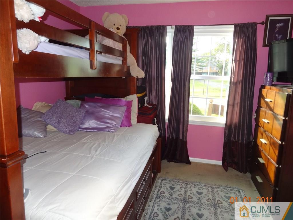 1019 Edpas Road, Unit 1019 New Brunswick, NJ 08901 - Photo 9 of 18 a bedroom with a bed and a flat screen tv