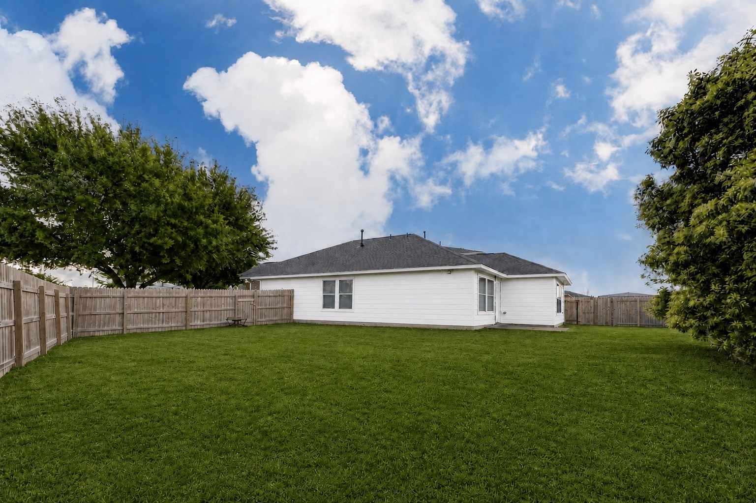 7039 Primrose Road Baytown, TX 77521 - Photo 24 of 25 Spacious fenced backyard with green lawn and room to enjoy