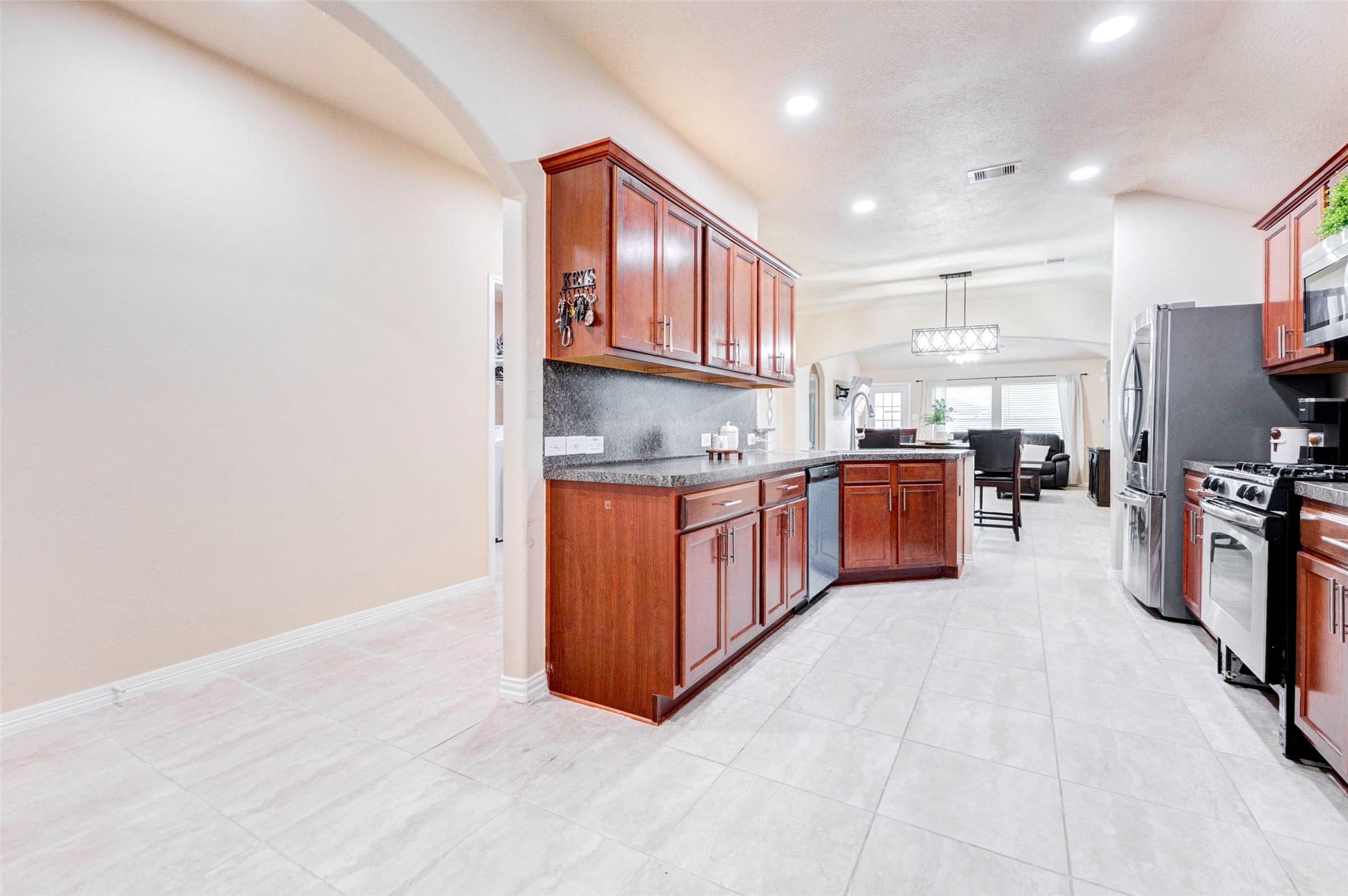 7039 Primrose Road Baytown, TX 77521 - Photo 5 of 25 Open kitchen with rich cabinetry, great storage, and breakfast bar