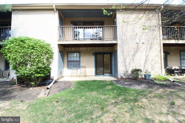 a view of house with yard and outdoor seating