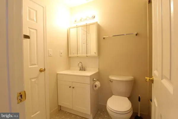 a bathroom with a toilet a sink and a mirror