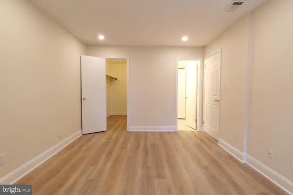 a view of an empty room and wooden floor