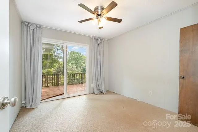 a view of a livingroom with a ceiling fan and window