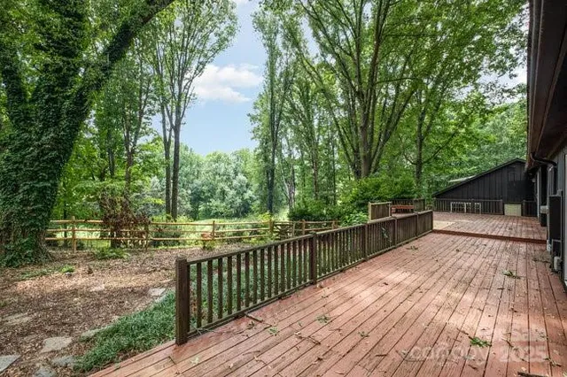 a view of backyard with deck and wooden floor