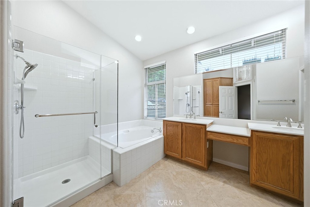 9379 Monarch Court Rancho Cucamonga, CA 91737 - Photo 12 of 19 a bathroom with a tub sink shower and mirror