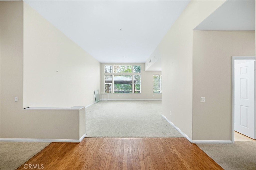 9379 Monarch Court Rancho Cucamonga, CA 91737 - Photo 8 of 19 an empty room with wooden floor and windows