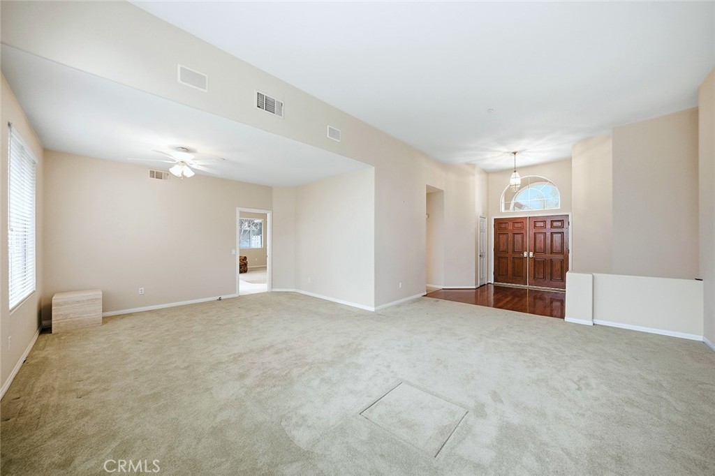 9379 Monarch Court Rancho Cucamonga, CA 91737 - Photo 9 of 19 a view of an empty room with wooden floor and entryway