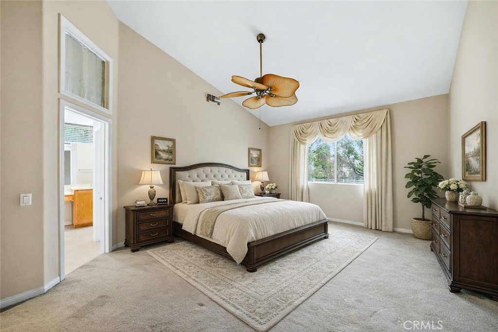 9379 Monarch Court Rancho Cucamonga, CA 91737 - Photo 10 of 19 a bedroom with a bed and a chandelier