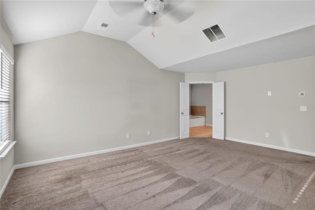 1553 Spring Hollow Way Stone Mountain, GA 30083 - Photo 13 of 25 a view of an empty room with a window