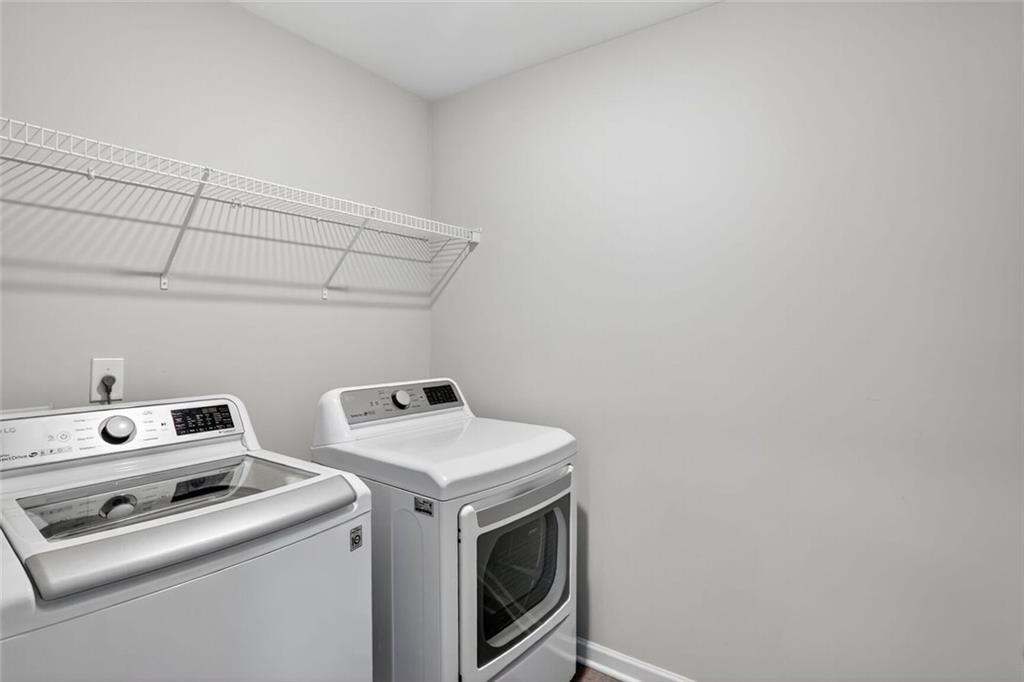 1553 Spring Hollow Way Stone Mountain, GA 30083 - Photo 18 of 25 a utility room with dryer and washer