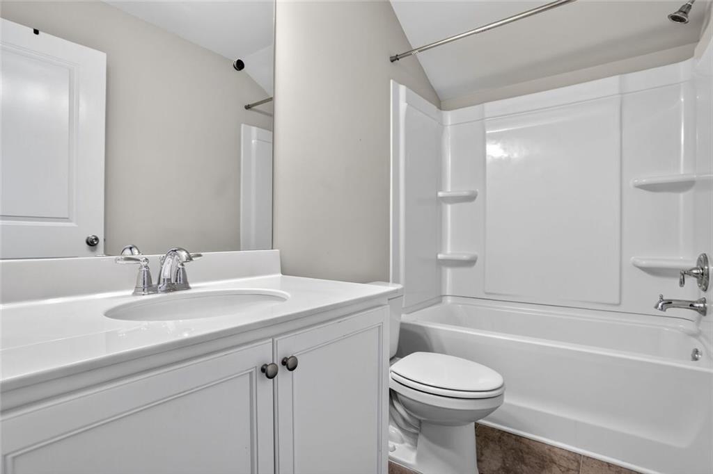 1553 Spring Hollow Way Stone Mountain, GA 30083 - Photo 23 of 25 a bathroom with a sink a toilet and a bathtub