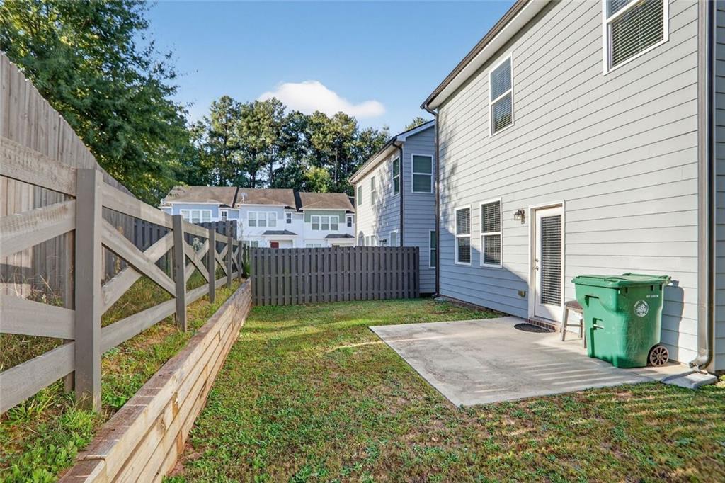1553 Spring Hollow Way Stone Mountain, GA 30083 - Photo 24 of 25 a view of a backyard with wooden fence