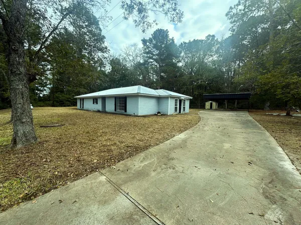 a view of house with yard