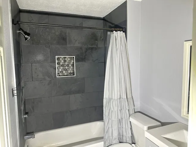 a bathroom with a shower and a tub