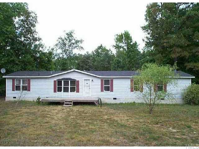3921 Quarry Road Zebulon, NC 27597 - Photo 1 of 1 a view of a house with a yard