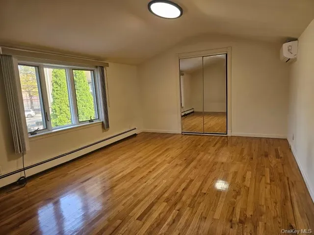 a view of a livingroom with wooden floor and window
