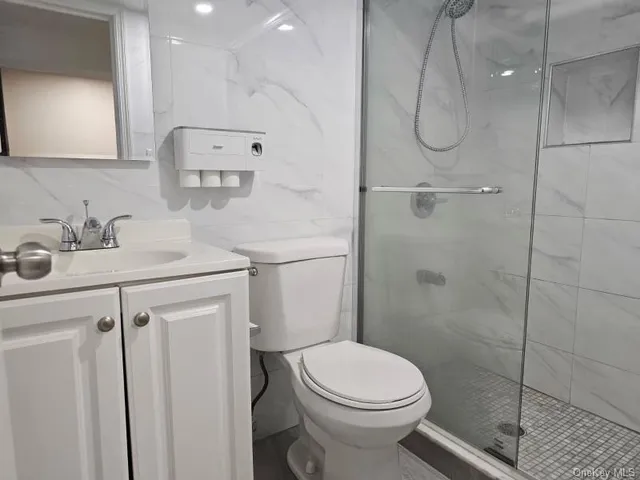 a bathroom with a sink toilet and shower