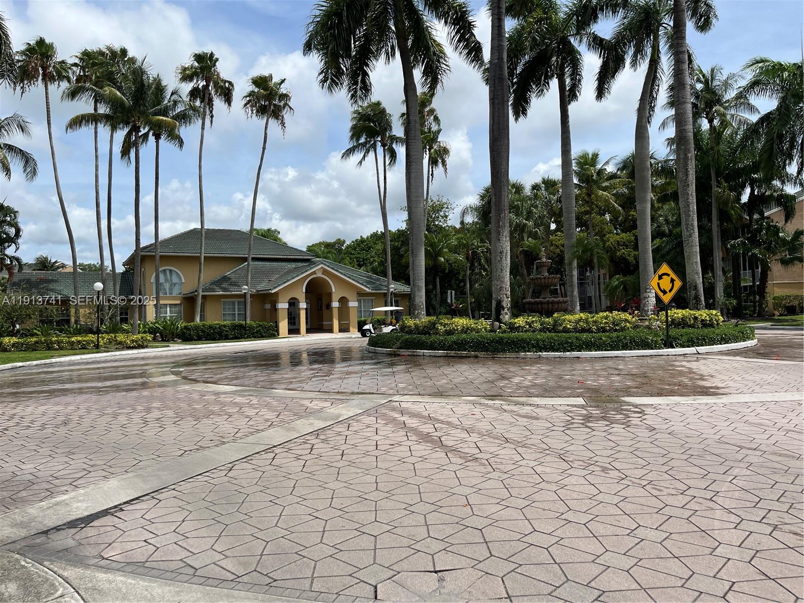 4055 West McNab Road, Unit H104 Pompano Beach, FL 33069 - Photo 14 of 14 a front view of house with yard and palm trees