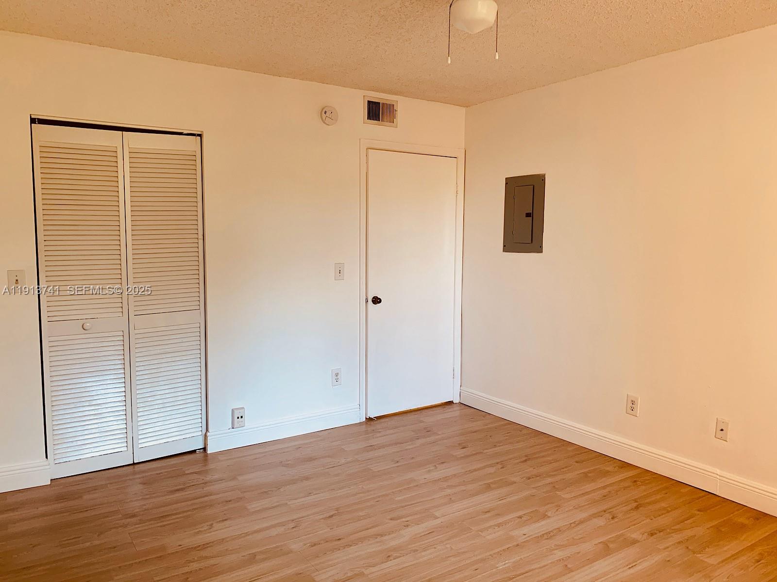 4055 West McNab Road, Unit H104 Pompano Beach, FL 33069 - Photo 3 of 14 a view of an empty room with wooden floor