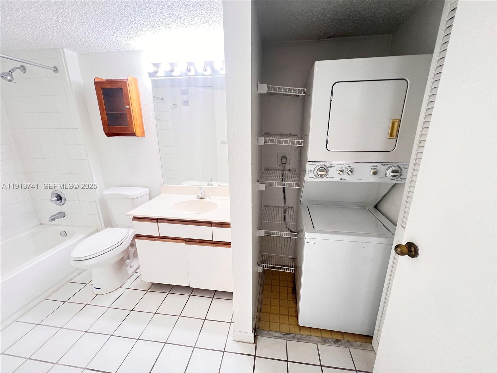 4055 West McNab Road, Unit H104 Pompano Beach, FL 33069 - Photo 8 of 14 a bathroom with a toilet sink and mirror