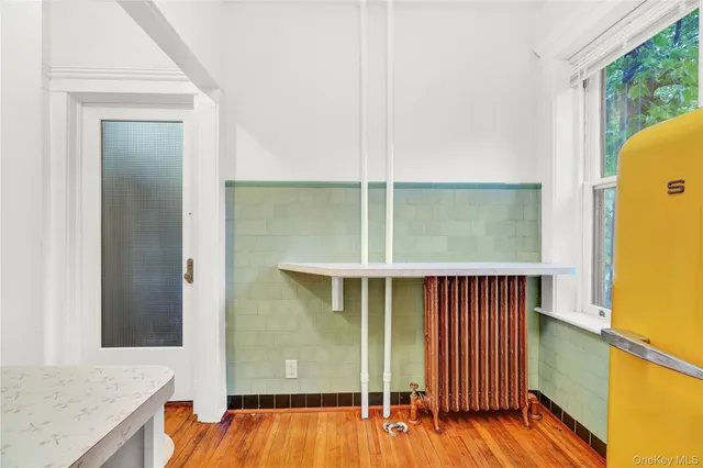 a view of front door with wooden floor