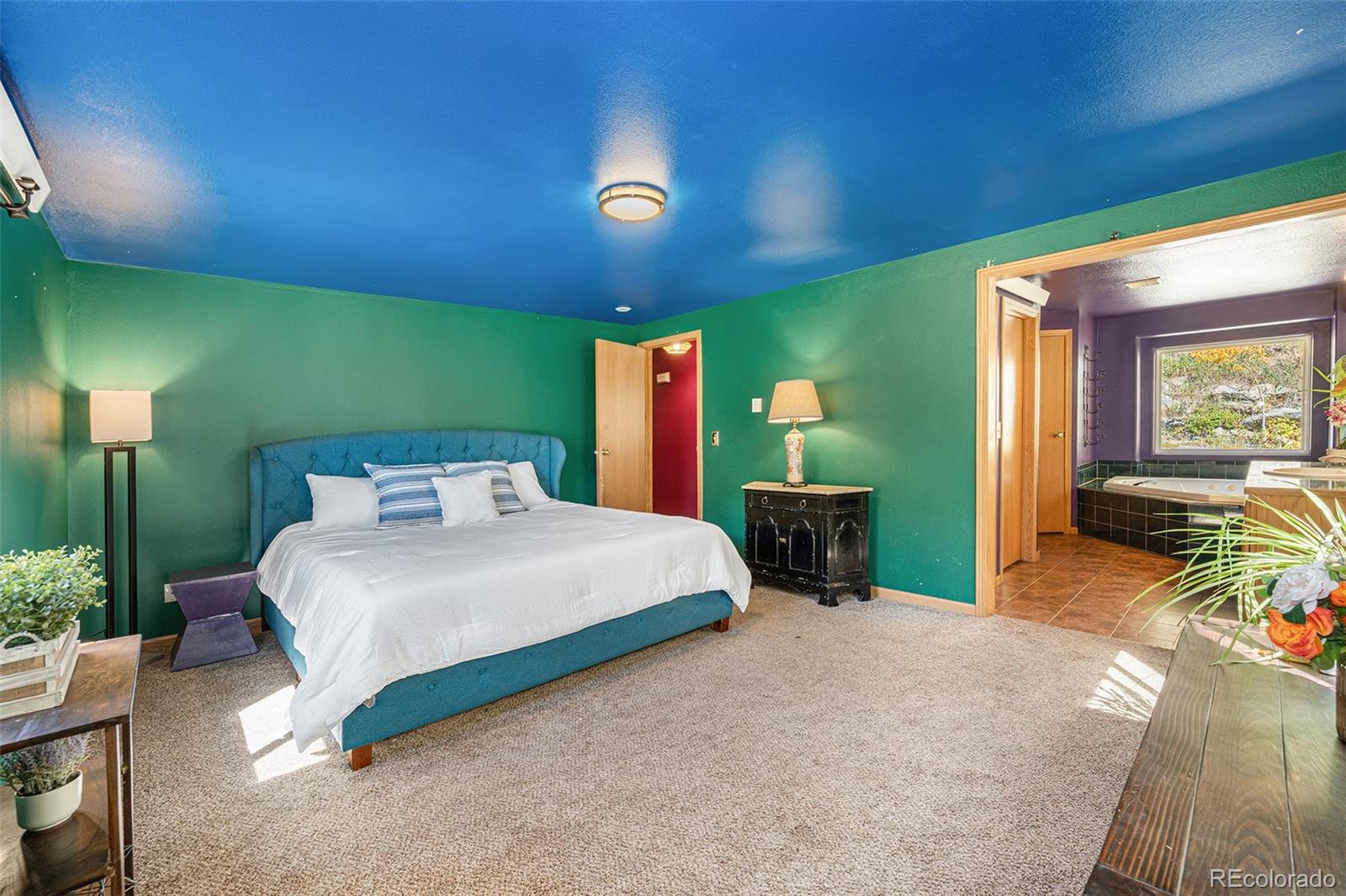 21795 Indian Springs Road Conifer, CO 80433 - Photo 14 of 29 a spacious bedroom with a bed and a table in it