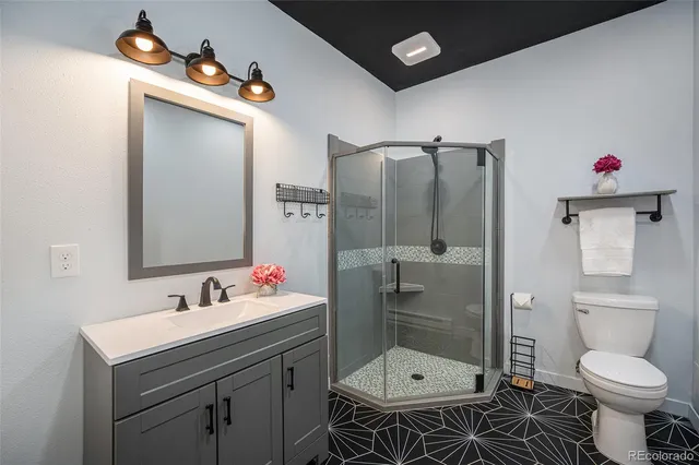a bathroom with a sink toilet and shower