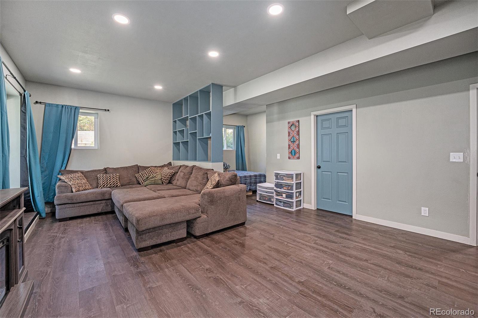 21795 Indian Springs Road Conifer, CO 80433 - Photo 20 of 29 a living room with furniture and a wooden floor