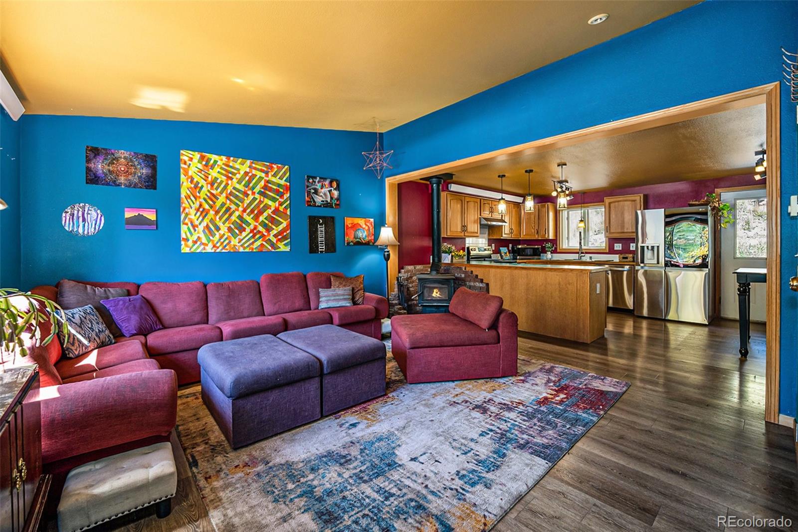 21795 Indian Springs Road Conifer, CO 80433 - Photo 2 of 29 a living room with furniture a rug and a table