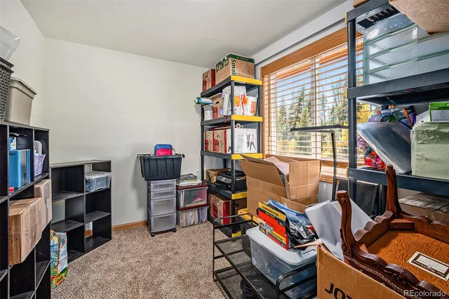 a living room with furniture a flat screen tv and a bookshelf