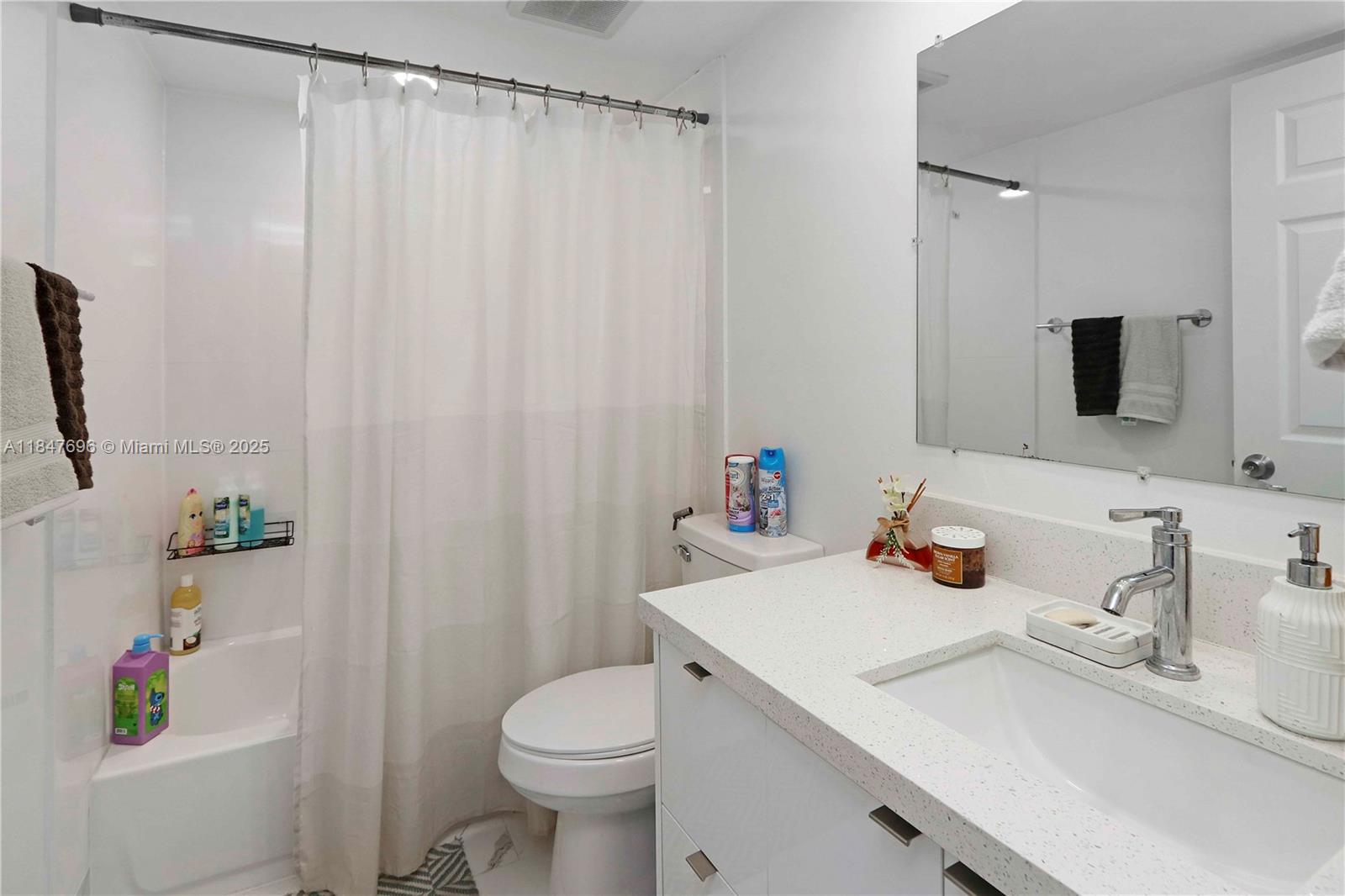 9917 West Okeechobee Road, Unit 3303 Hialeah Gardens, FL 33016 - Photo 15 of 26 a bathroom with a sink toilet and shower