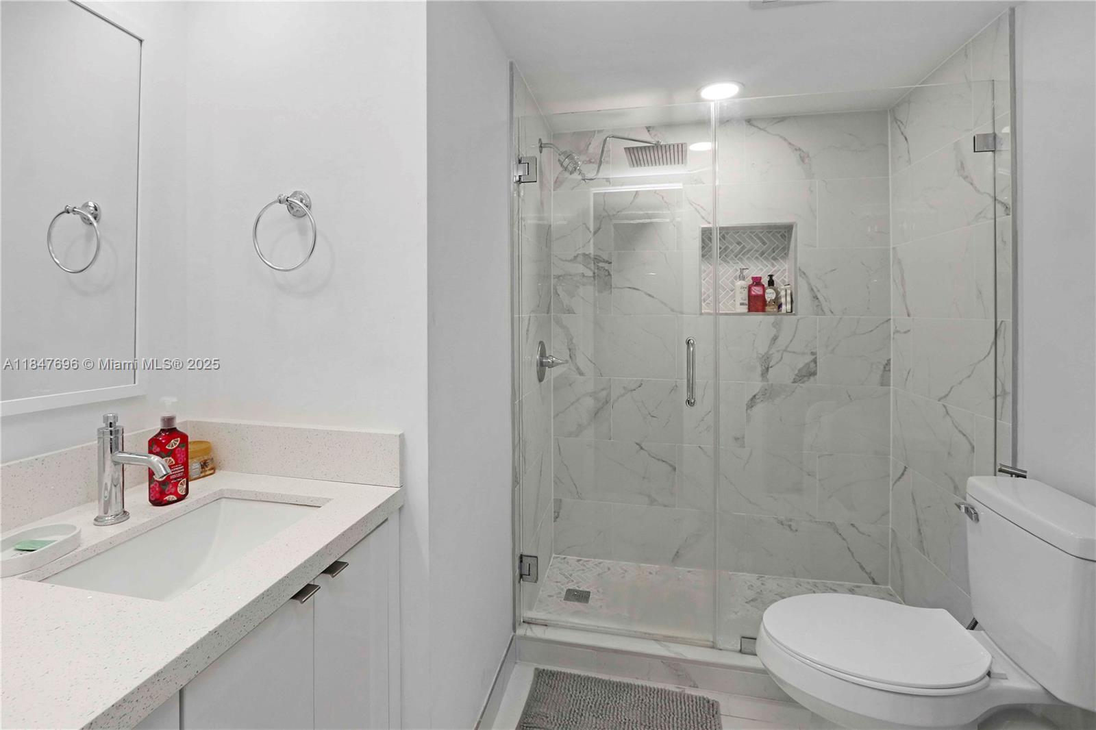 9917 West Okeechobee Road, Unit 3303 Hialeah Gardens, FL 33016 - Photo 16 of 26 a bathroom with a sink toilet and shower