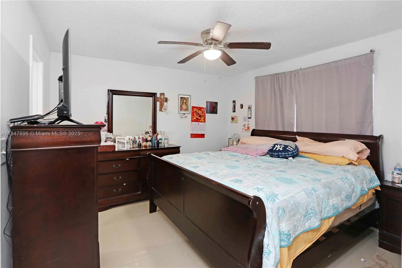 9917 West Okeechobee Road, Unit 3303 Hialeah Gardens, FL 33016 - Photo 19 of 26 a bedroom with a bed and a dresser