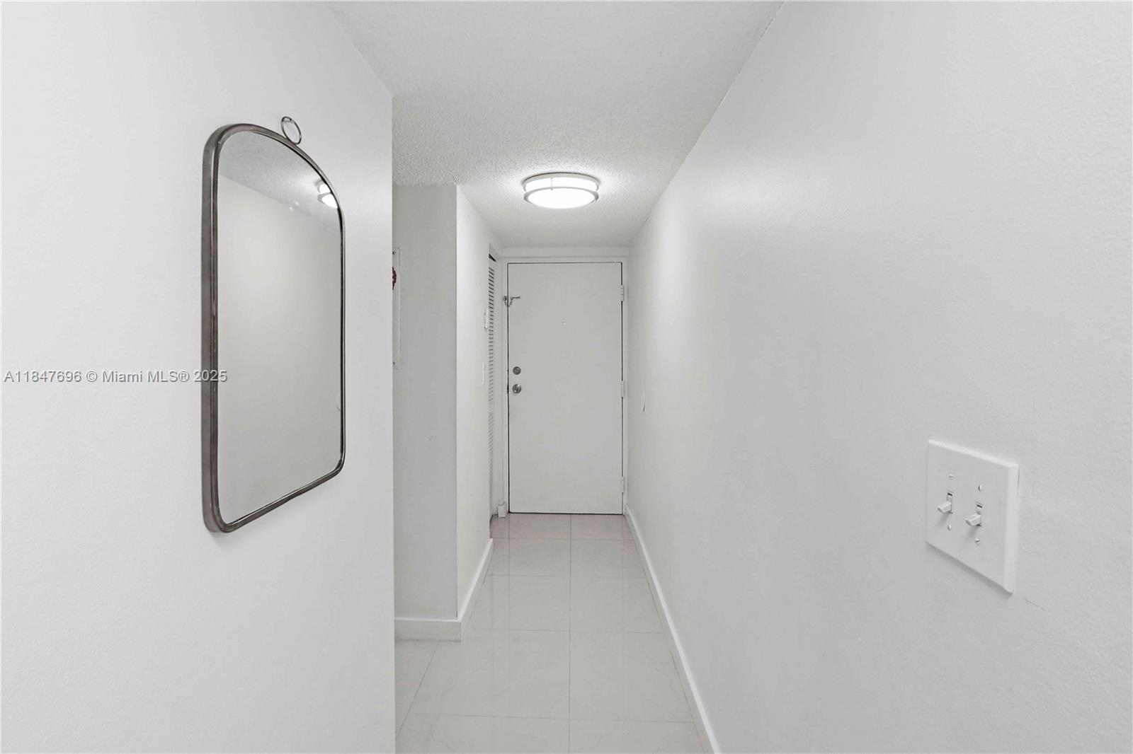 9917 West Okeechobee Road, Unit 3303 Hialeah Gardens, FL 33016 - Photo 7 of 26 a view of a bathroom from a corridor