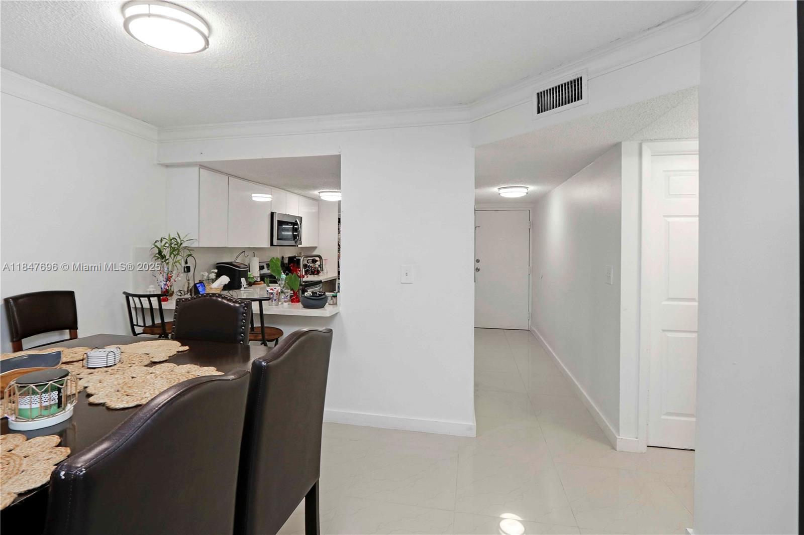 9917 West Okeechobee Road, Unit 3303 Hialeah Gardens, FL 33016 - Photo 8 of 26 a living room with furniture and a flat screen tv