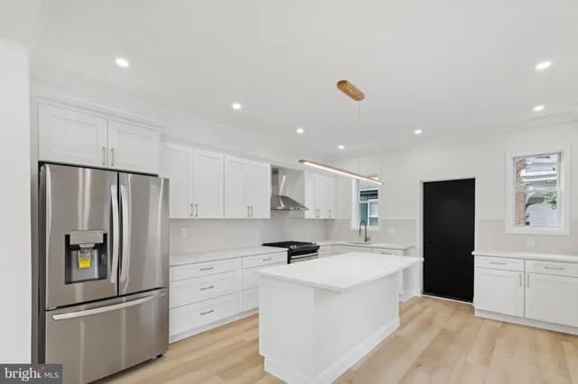 a large kitchen with cabinets and stainless steel appliances