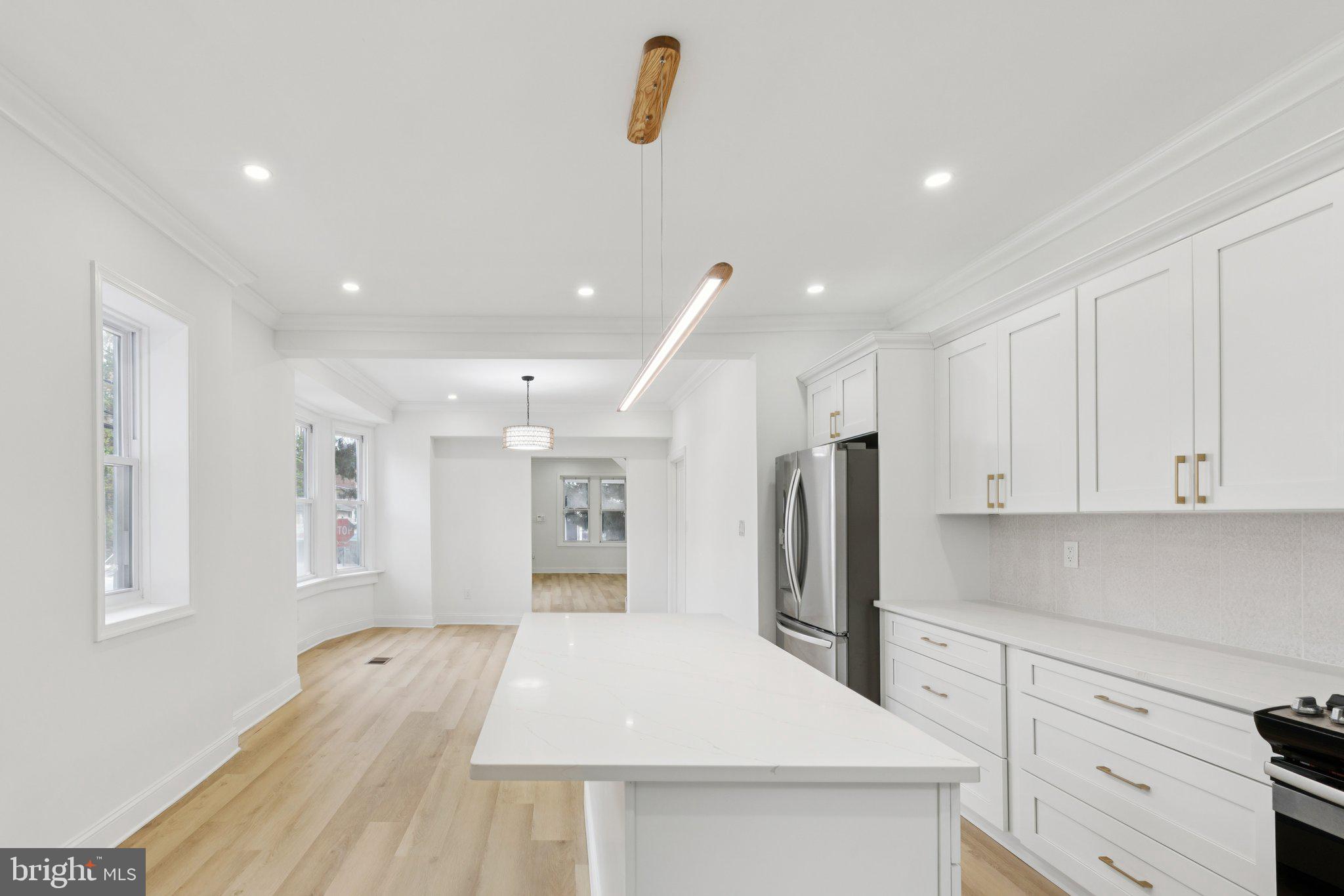 137 Manheim Street Philadelphia, PA 19144 - Photo 15 of 81 a kitchen with stainless steel appliances kitchen island sink refrigerator and cabinets