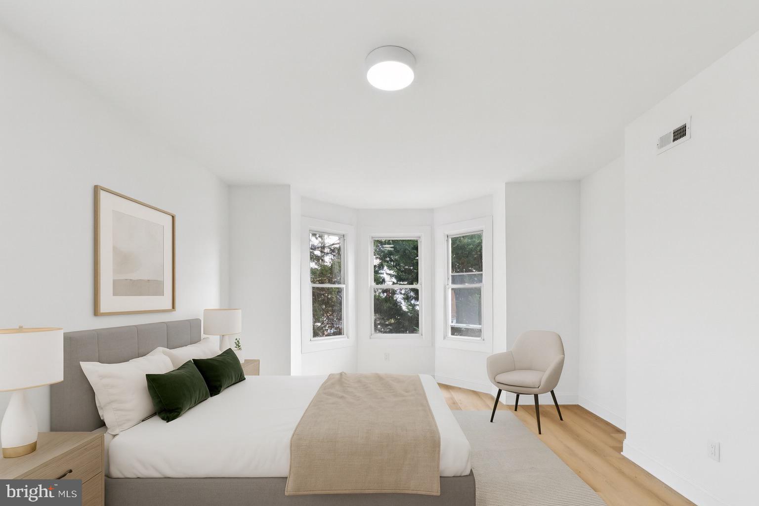 137 Manheim Street Philadelphia, PA 19144 - Photo 20 of 81 a bedroom with a bed and wooden floor