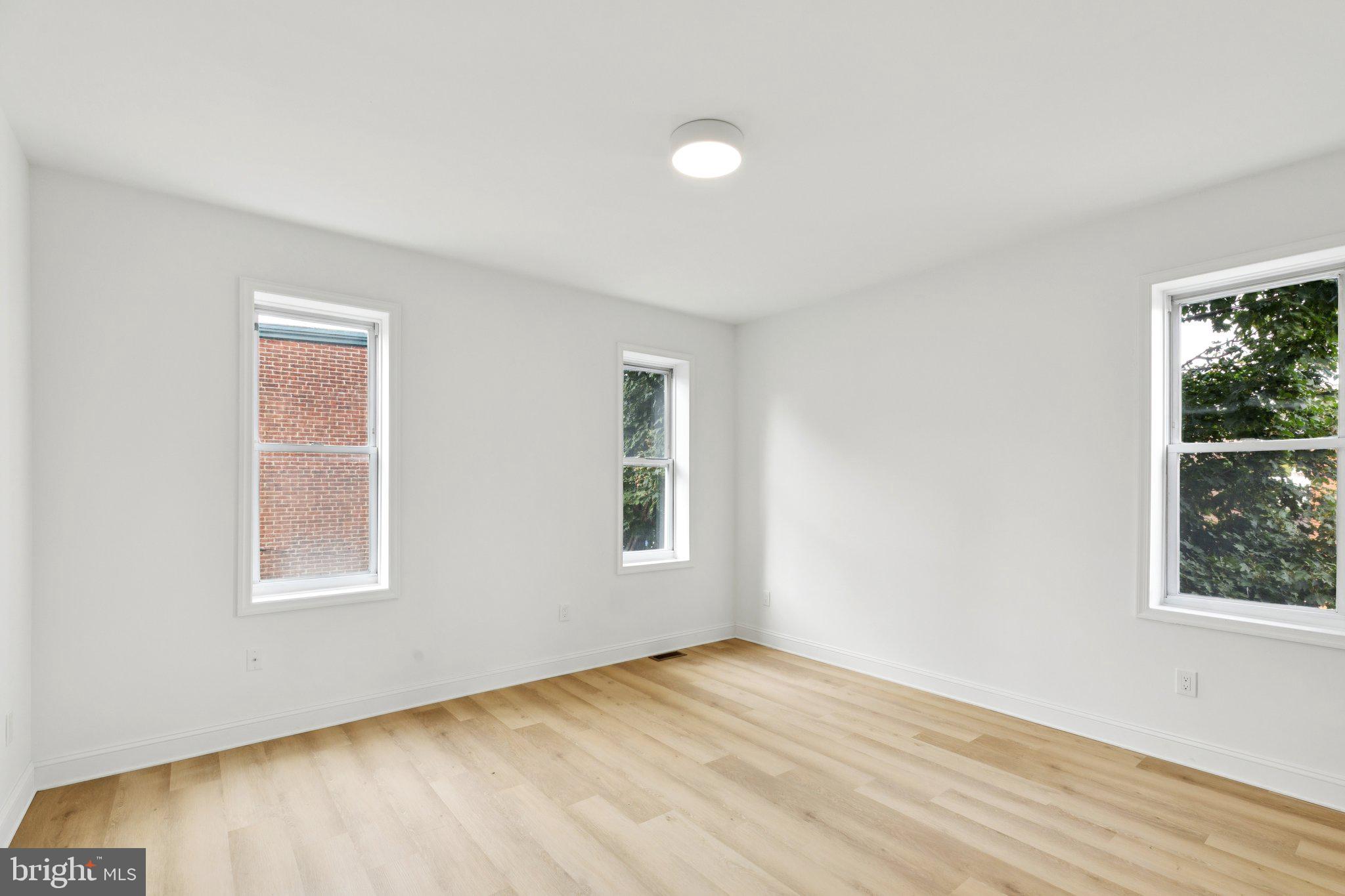 137 Manheim Street Philadelphia, PA 19144 - Photo 27 of 81 an empty room with wooden floor and windows