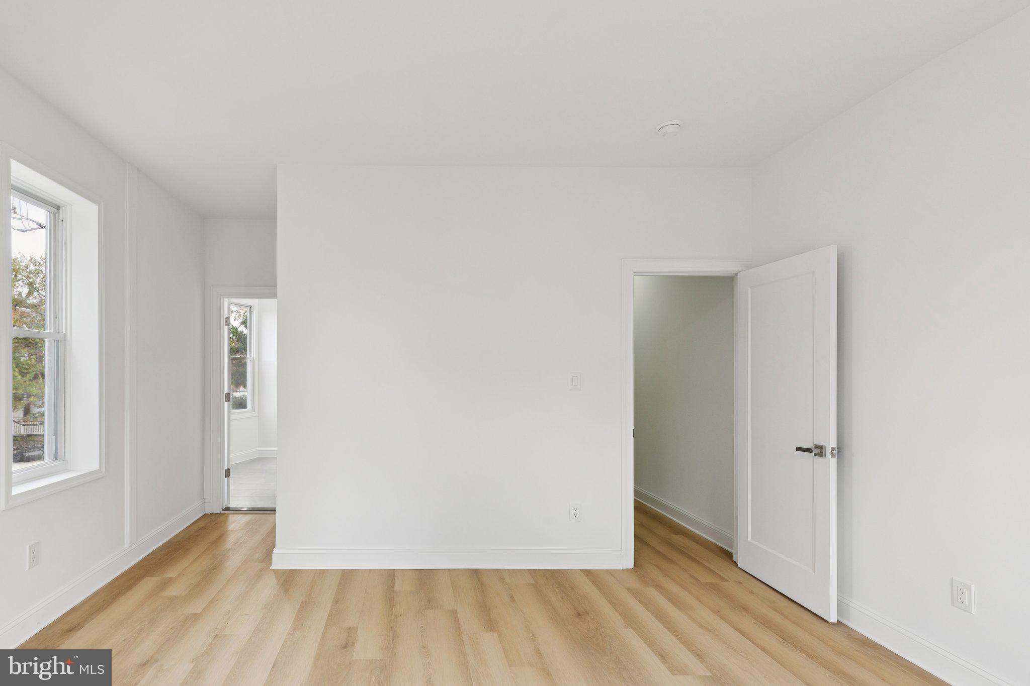 137 Manheim Street Philadelphia, PA 19144 - Photo 28 of 81 an empty room with wooden floor and windows