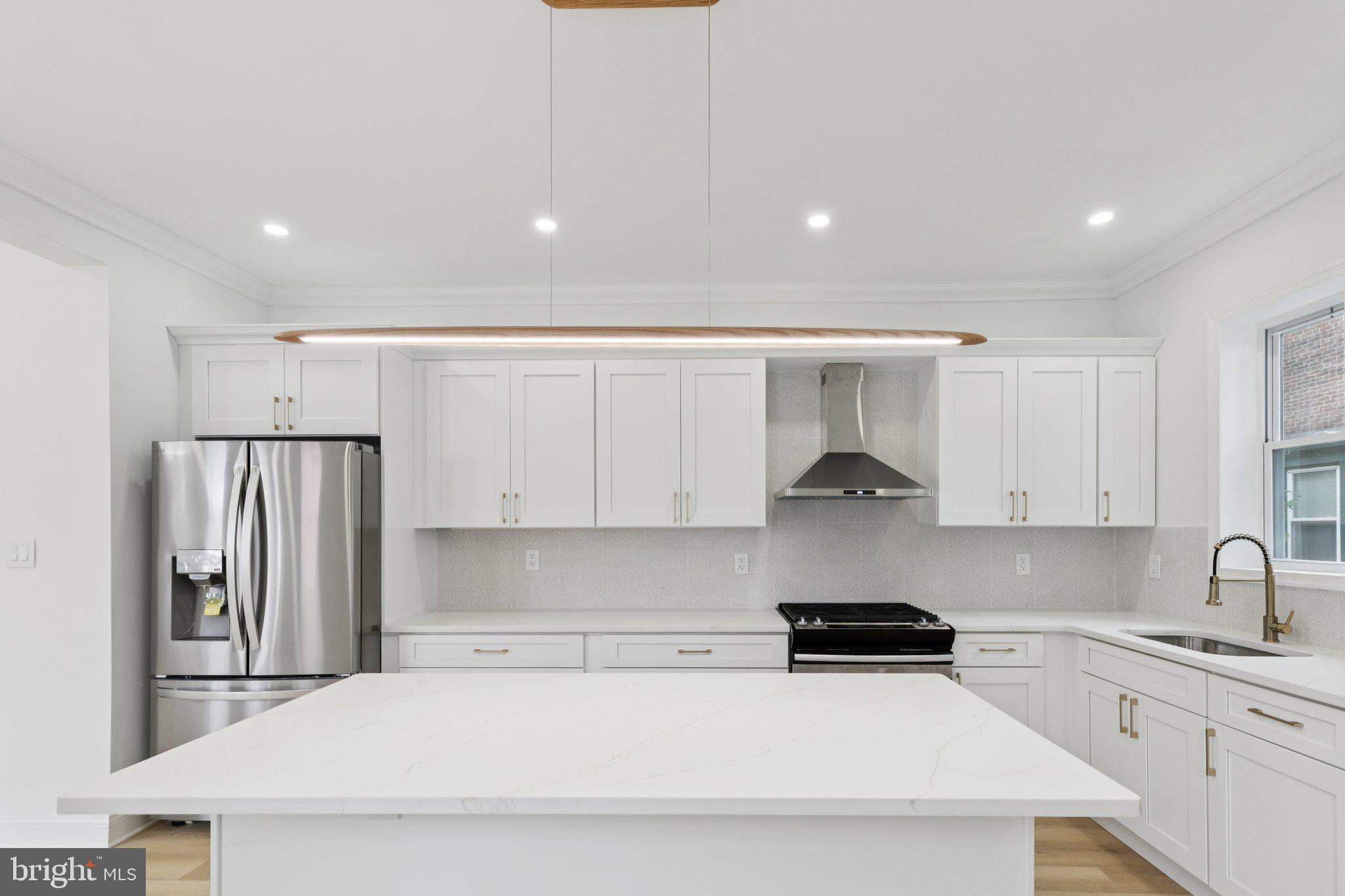 137 Manheim Street Philadelphia, PA 19144 - Photo 3 of 81 a kitchen with stainless steel appliances a refrigerator a stove a sink and white cabinets