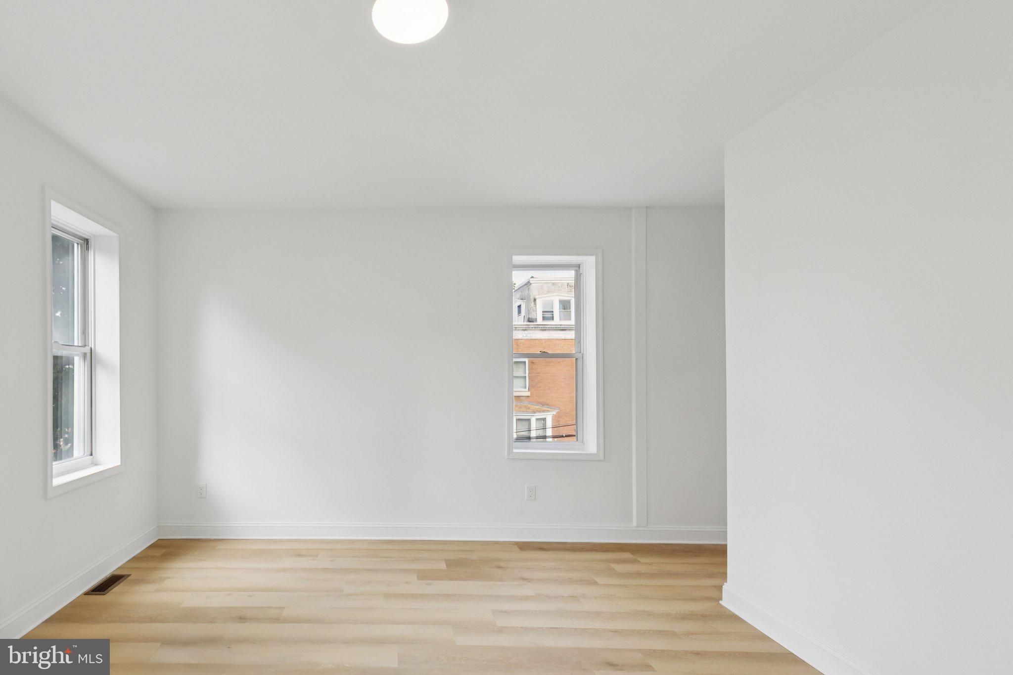 137 Manheim Street Philadelphia, PA 19144 - Photo 31 of 81 a view of an empty room with wooden floor and a window