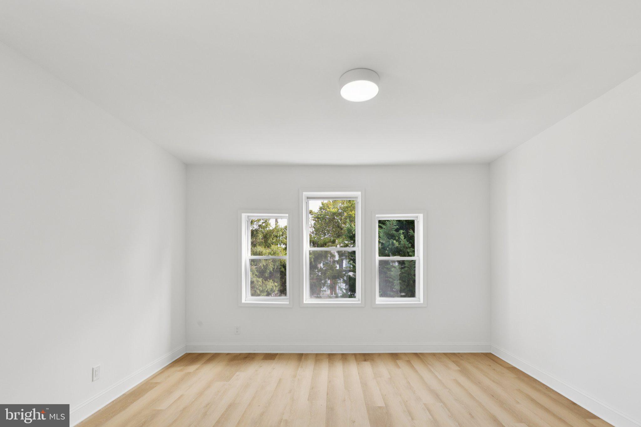 137 Manheim Street Philadelphia, PA 19144 - Photo 43 of 81 an empty room with wooden floor and windows