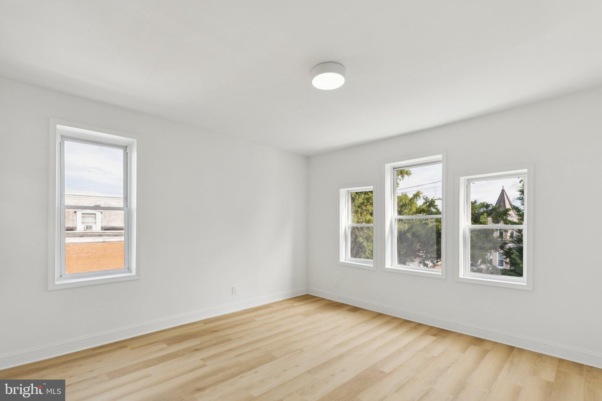 137 Manheim Street Philadelphia, PA 19144 - Photo 44 of 81 an empty room with wooden floor and windows