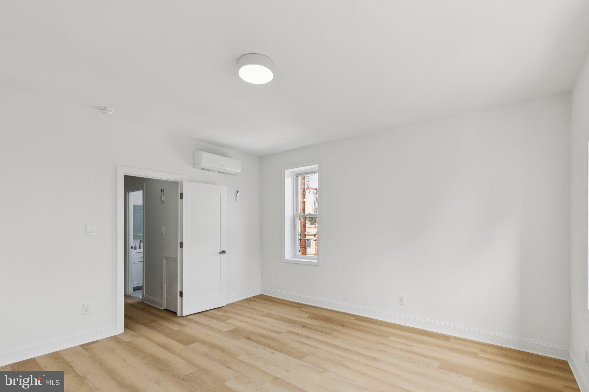 137 Manheim Street Philadelphia, PA 19144 - Photo 46 of 81 an empty room with wooden floor and windows
