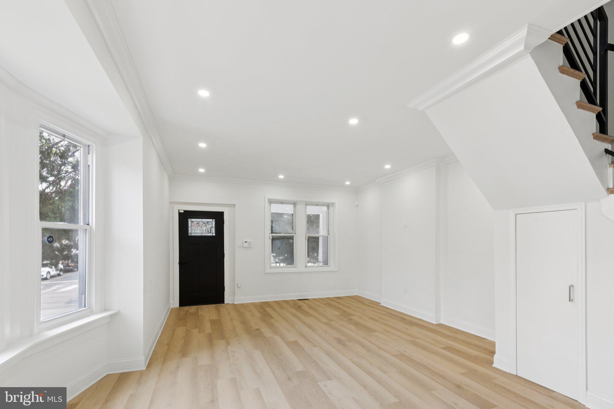 137 Manheim Street Philadelphia, PA 19144 - Photo 5 of 81 a view of an empty room with window and wooden floor