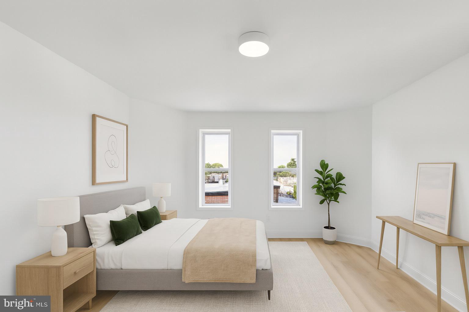 137 Manheim Street Philadelphia, PA 19144 - Photo 61 of 81 a bedroom with a large bed and a potted plant